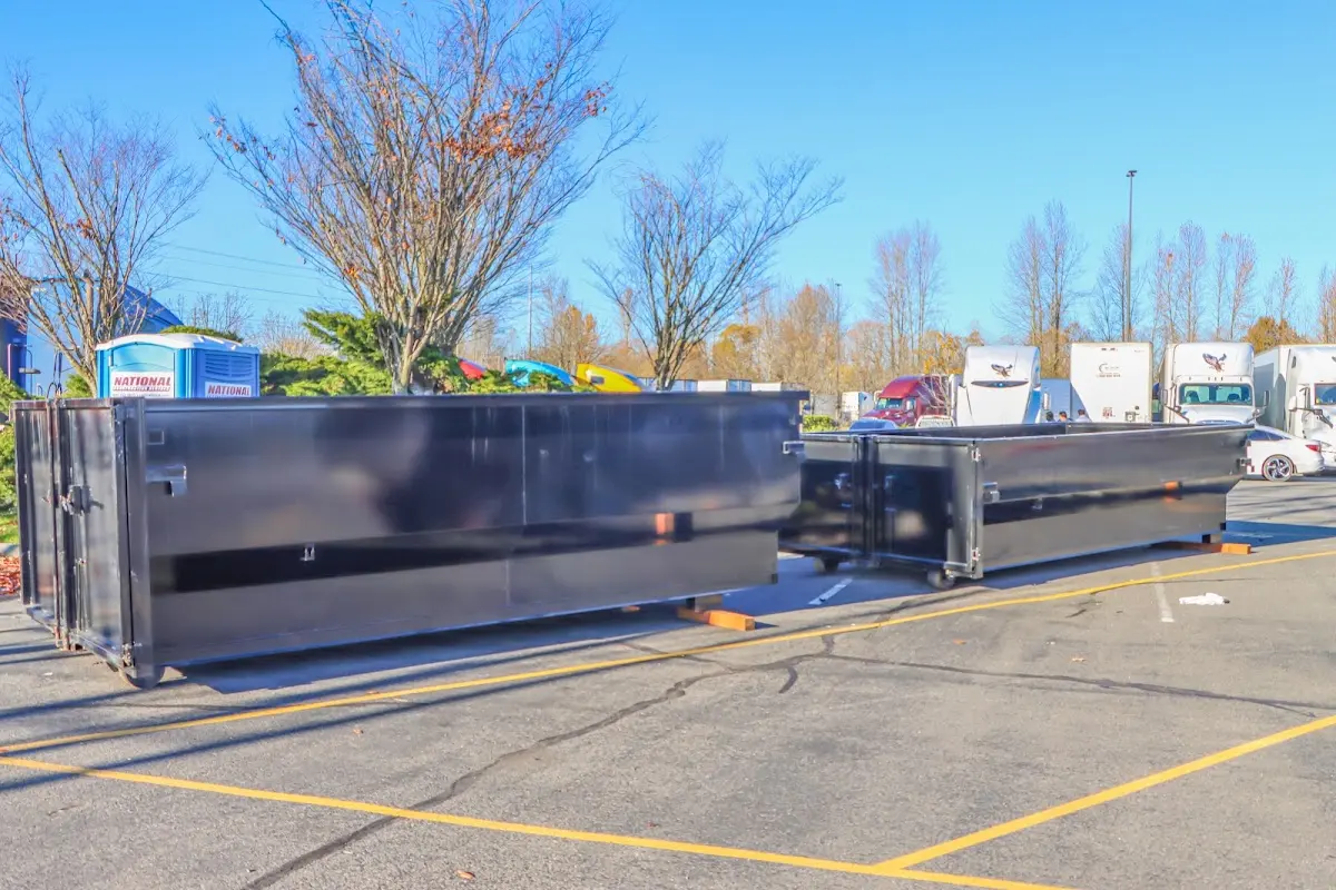 Professional dumpster rental service with roll-off container on residential driveway in Chesterland